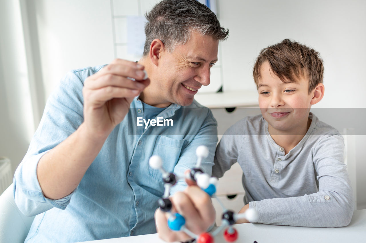 Father teaching son at home