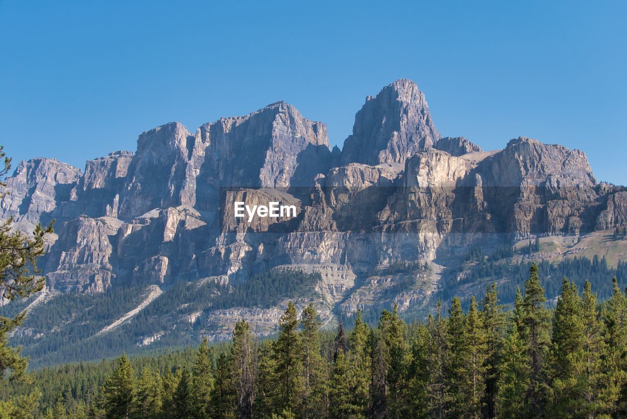 Scenic view of mountains against clear blue sky