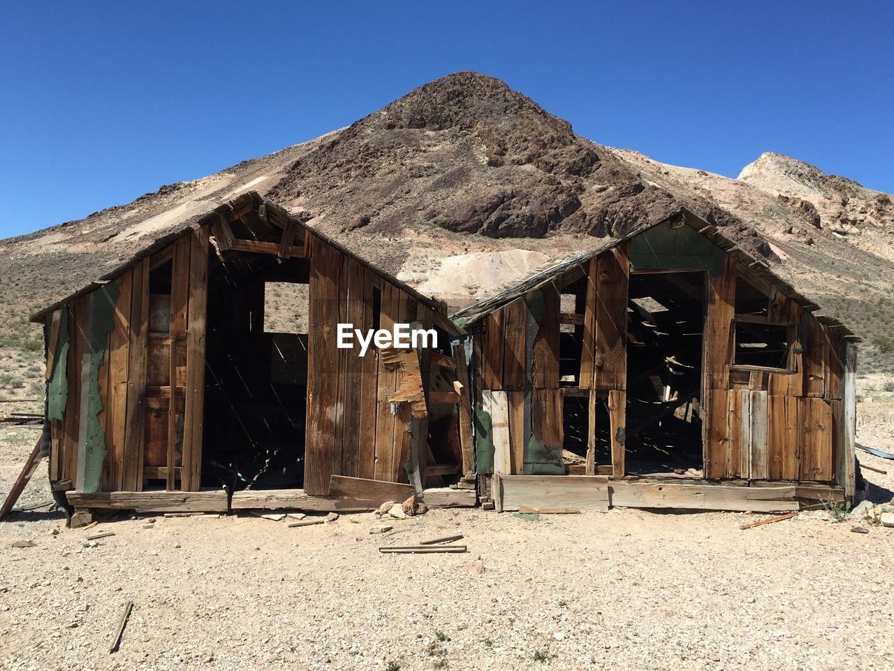 Abandoned built structure against rocky landscape