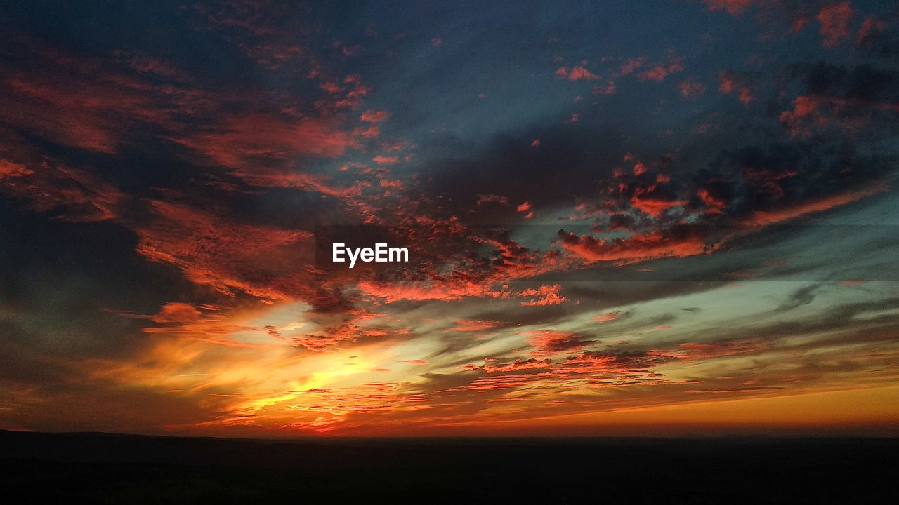 Low angle view of dramatic sky during sunset