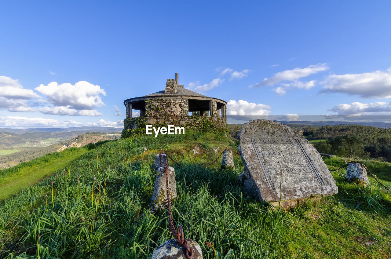 Old building on field against sky