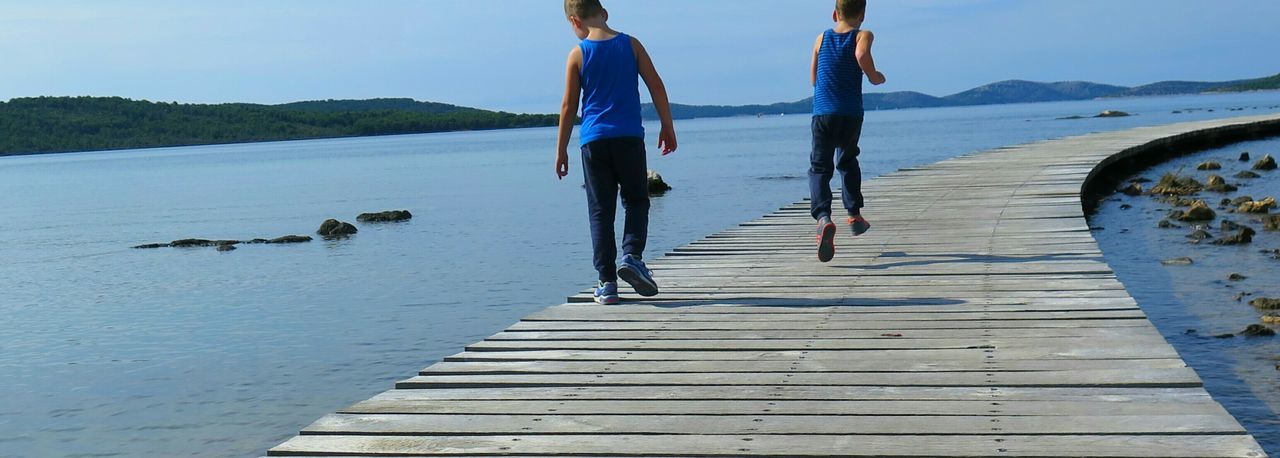 VIEW OF PEOPLE WALKING ON BOARDWALK