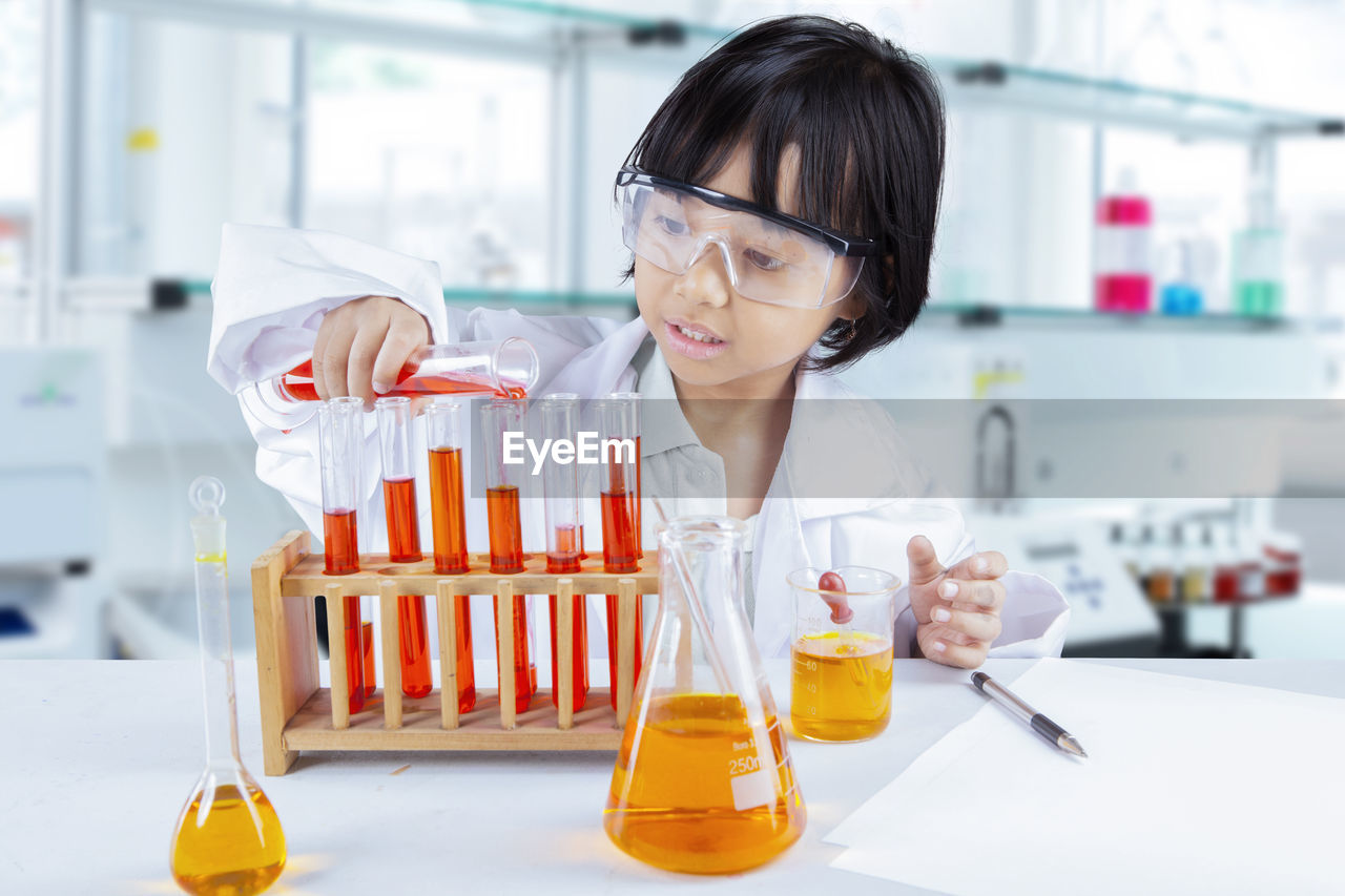 Girl doing scientific experiment in laboratory