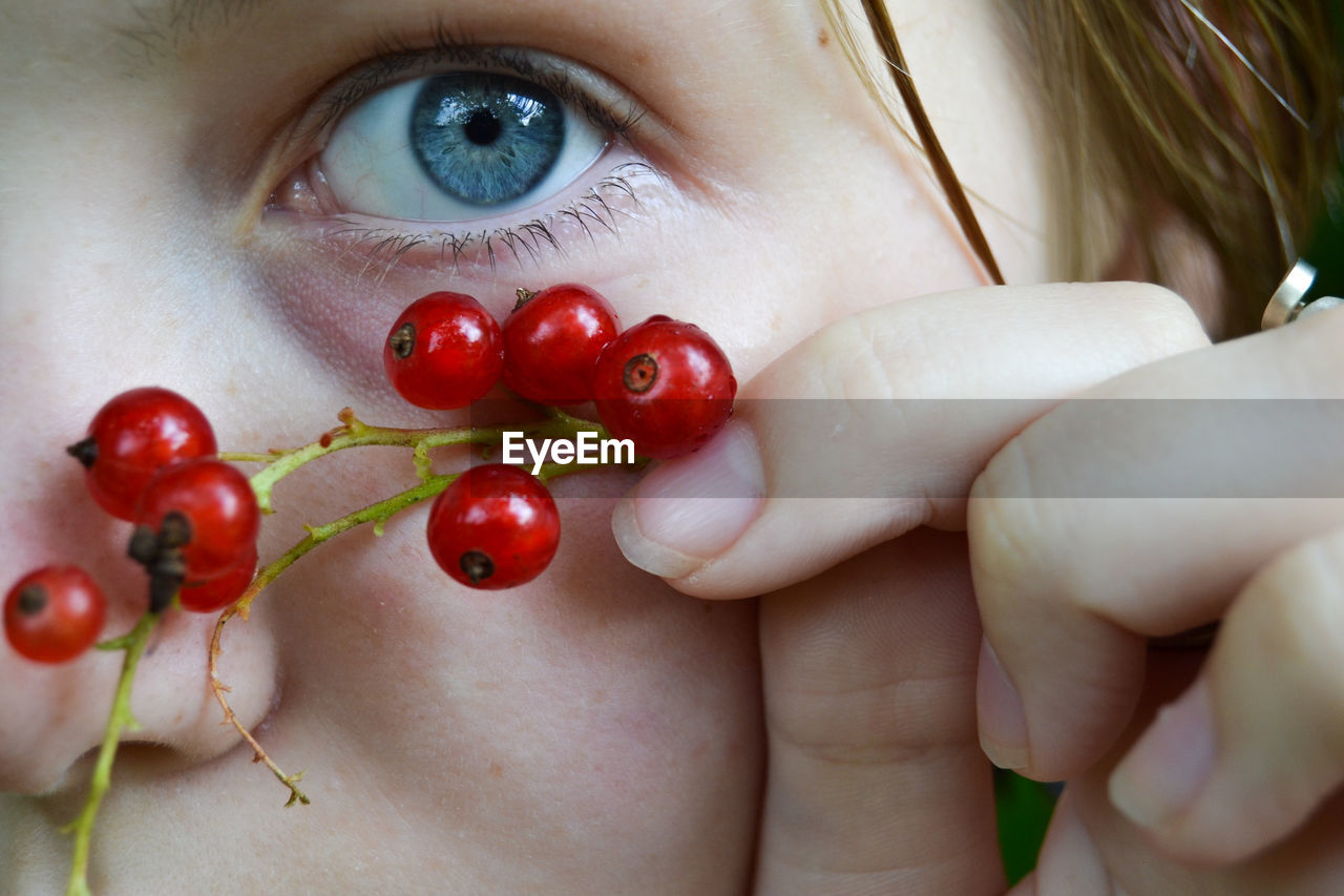 Close-up of a girl's eye with currants