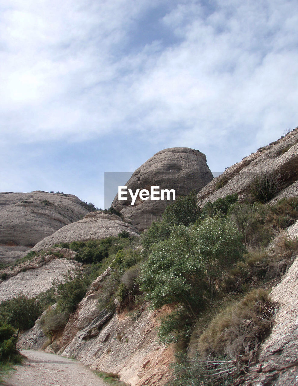 Scenic view of mountains against cloudy sky