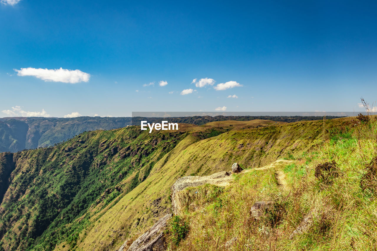 Misty mountain range covered with white mist and amazing blue sky