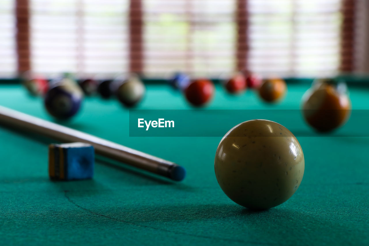 White ball and cue stick on pool table