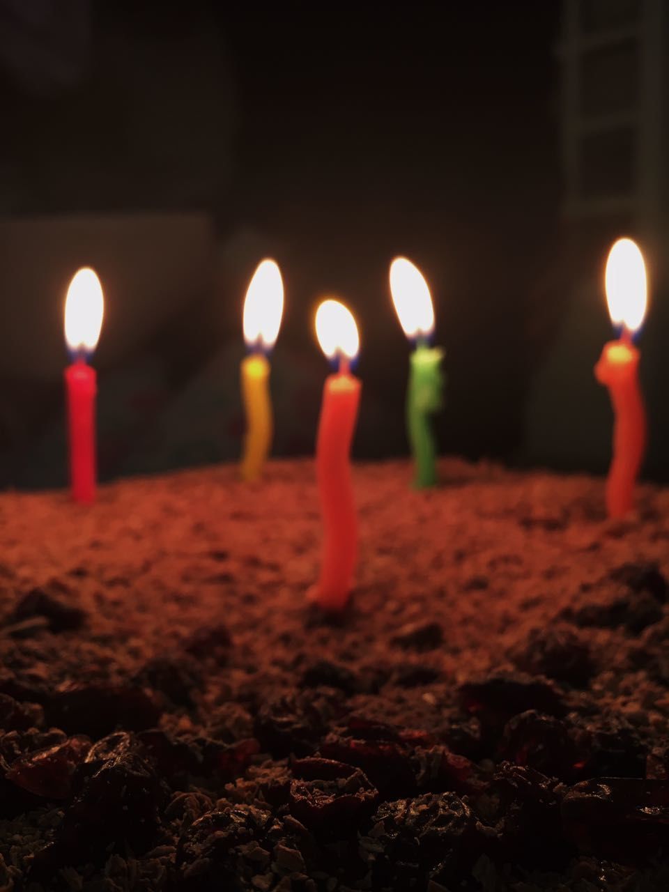 CLOSE-UP OF ILLUMINATED CANDLES ON THE NIGHT