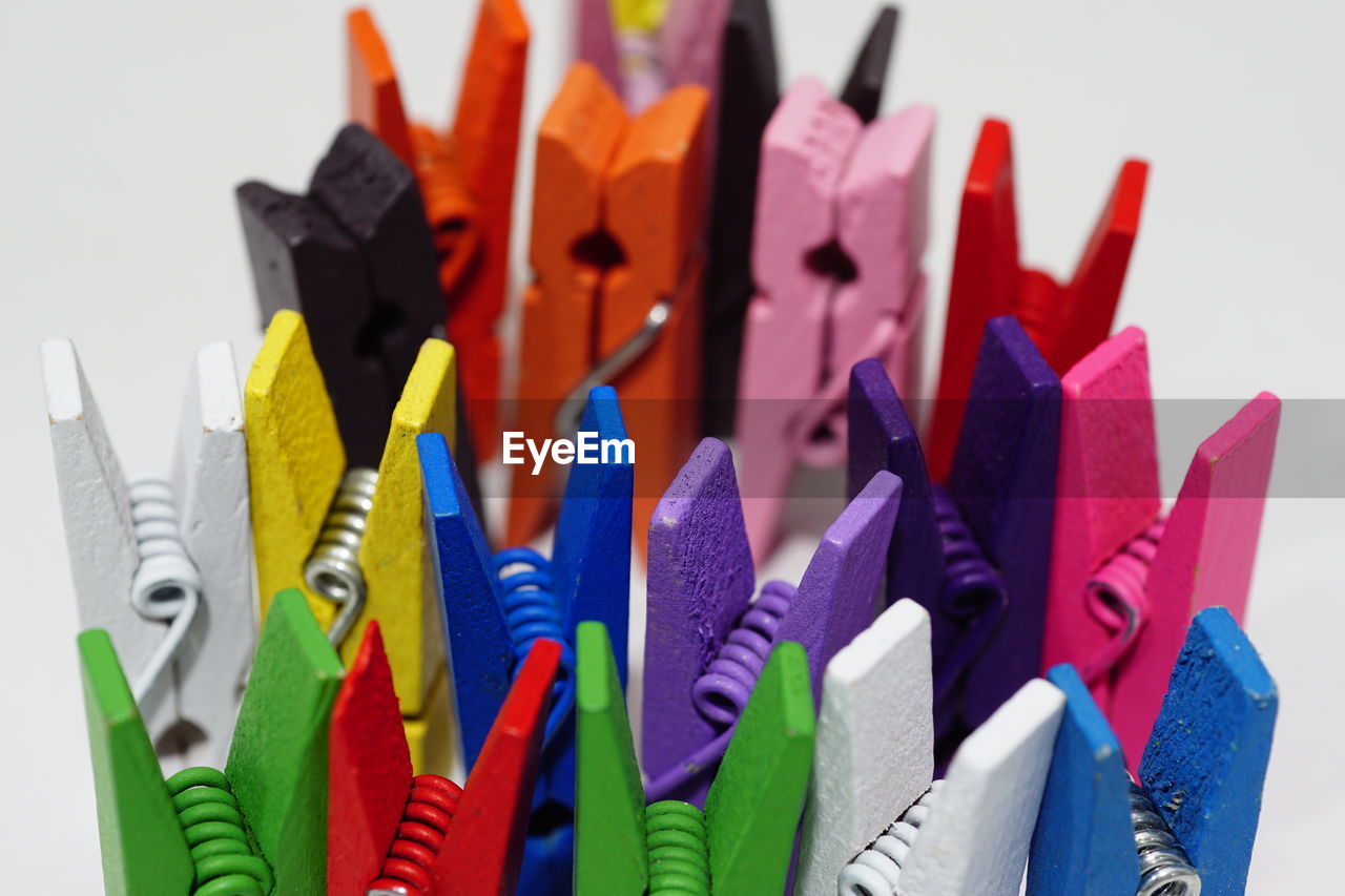 Close-up of multi colored picture clamps on table