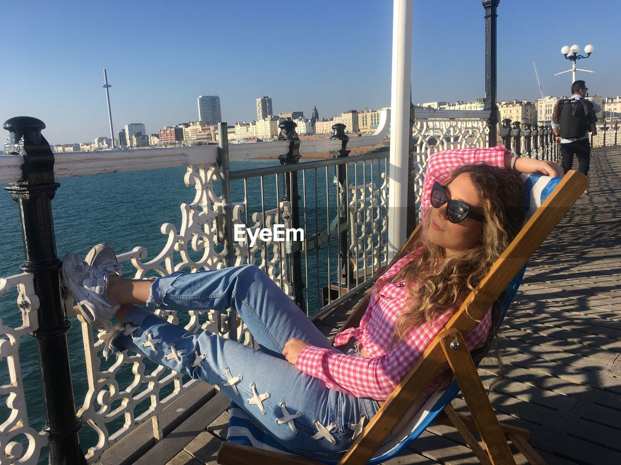 WOMAN SITTING ON BOAT IN A CITY