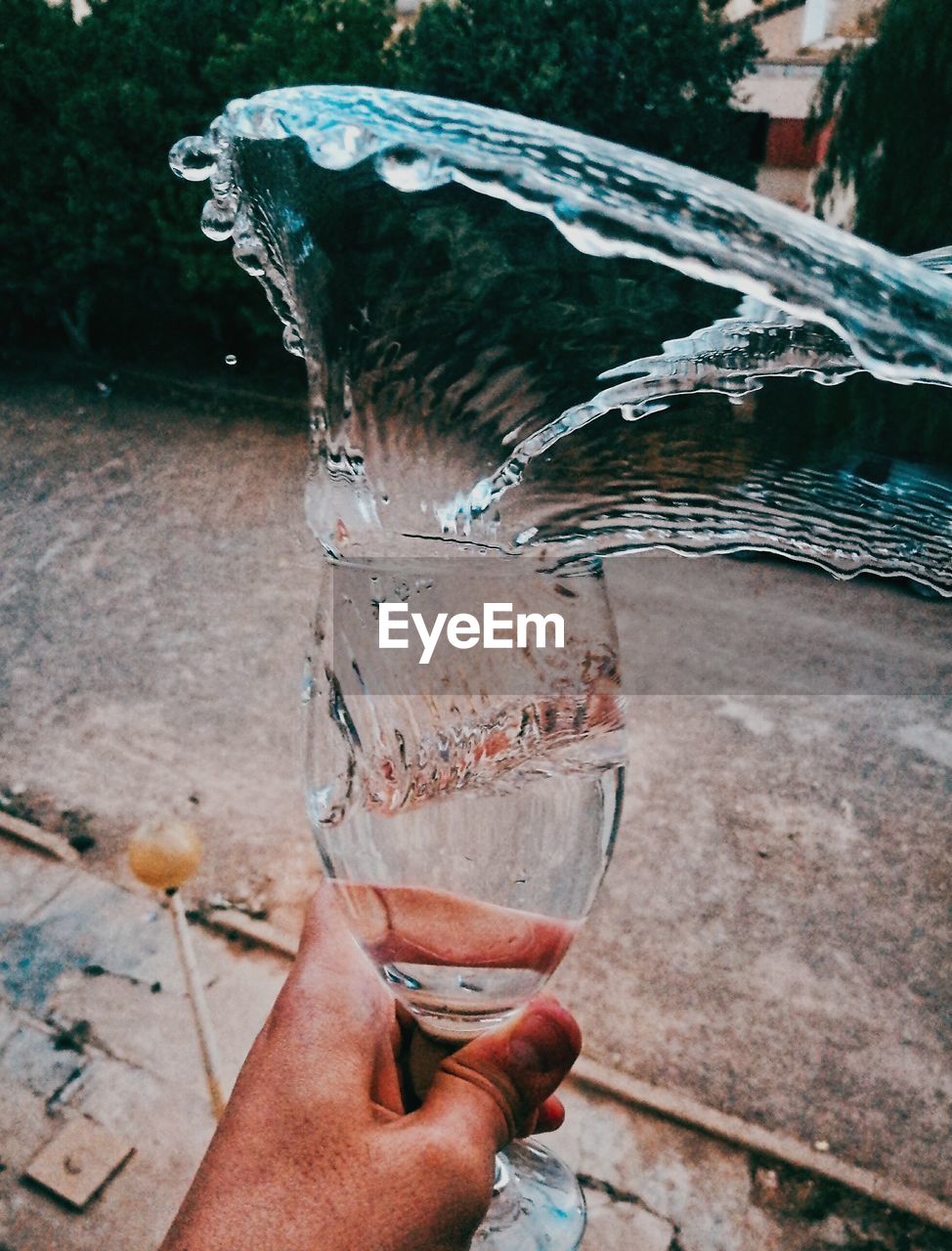 Midsection of person drinking glass with water