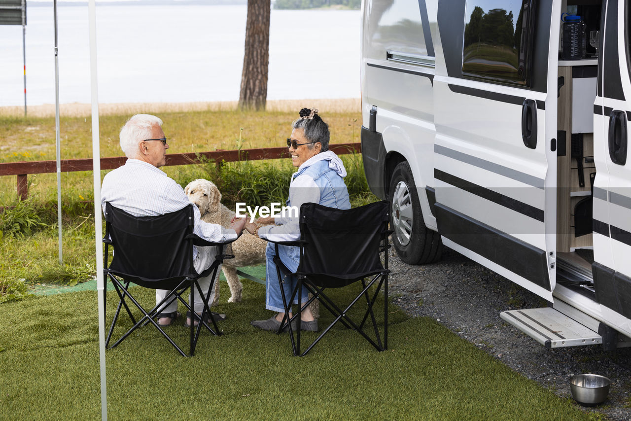 Senior couple with dog camping