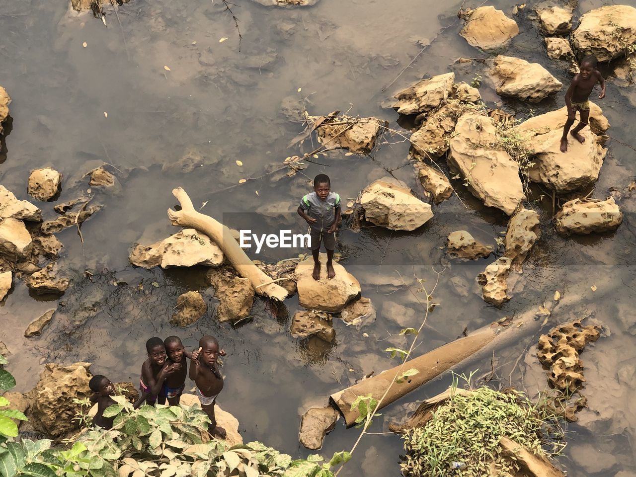 HIGH ANGLE VIEW OF MEN ON ROCK FORMATION