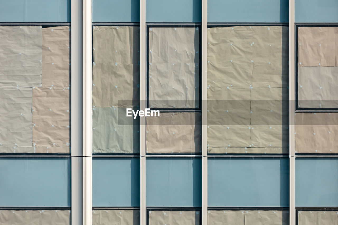 Beautiful texture of glass windows of condominium with crumple paper attachment for sun blocking