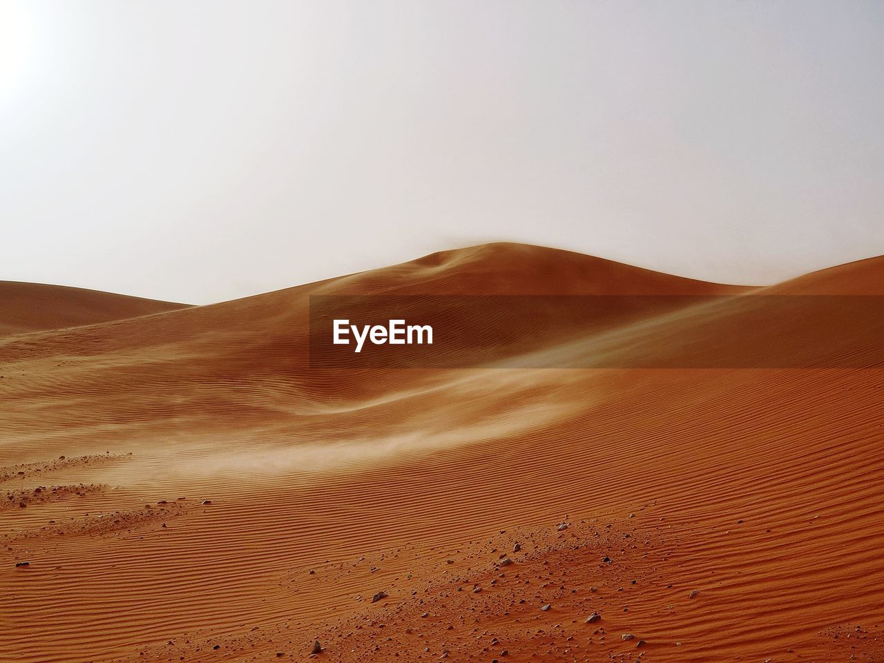 Sand dune in desert against clear sky