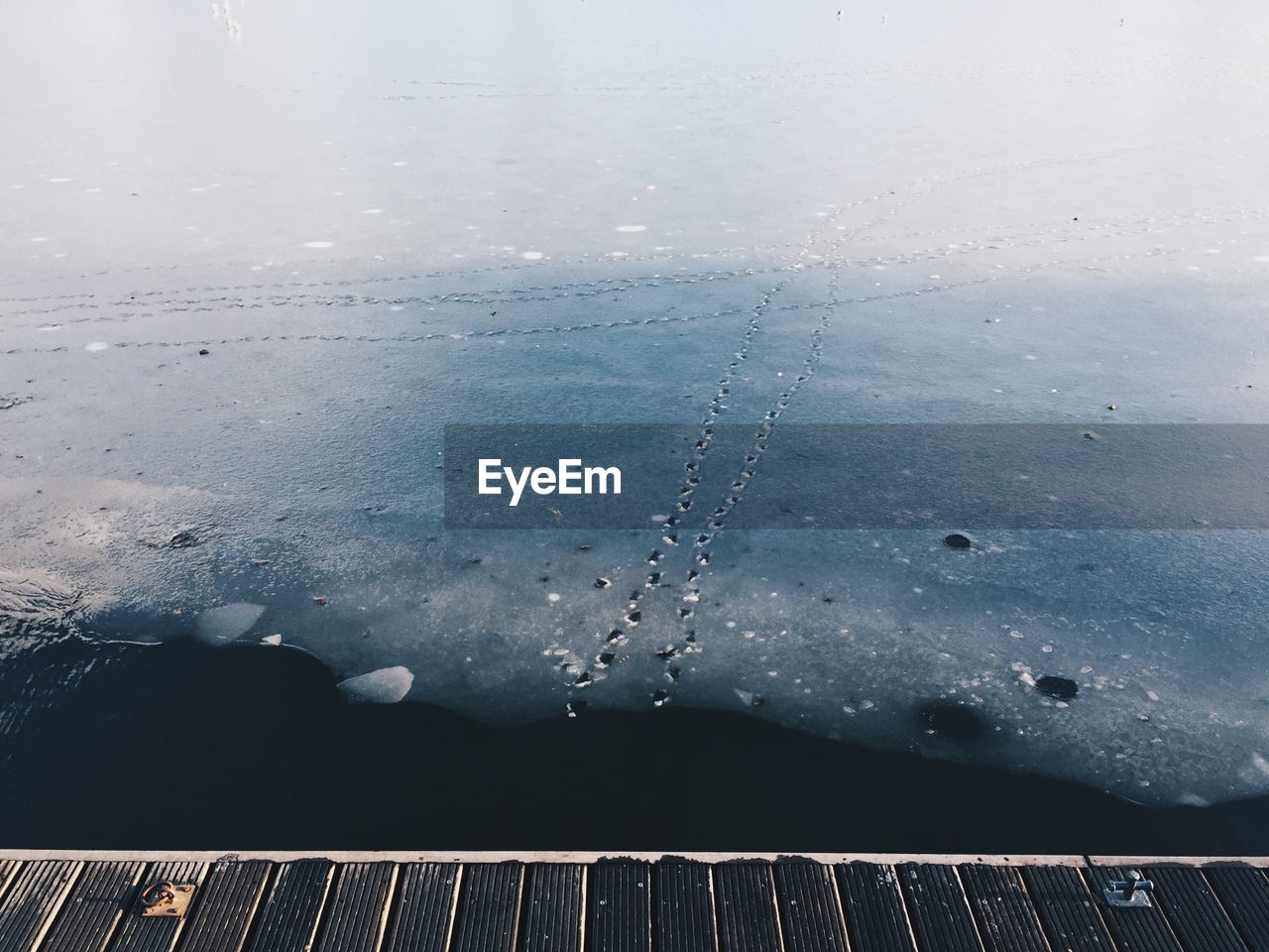 CLOSE-UP OF FROZEN WATER AGAINST SKY