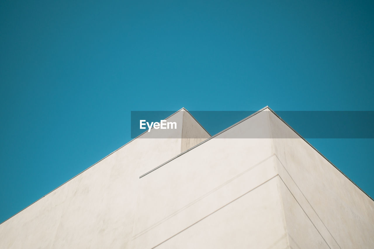 Low angle view of building against clear blue sky