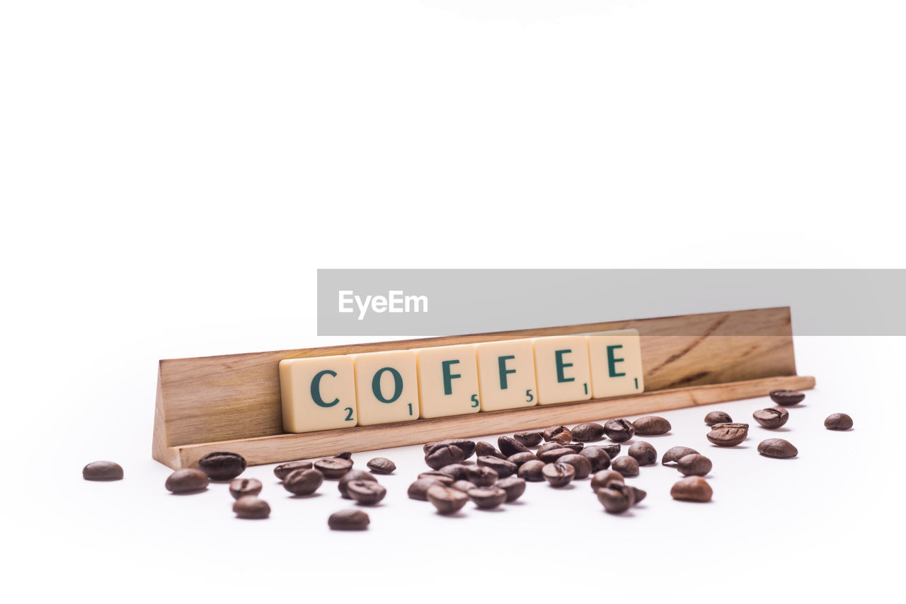 Information sign and roasted coffee beans on white background