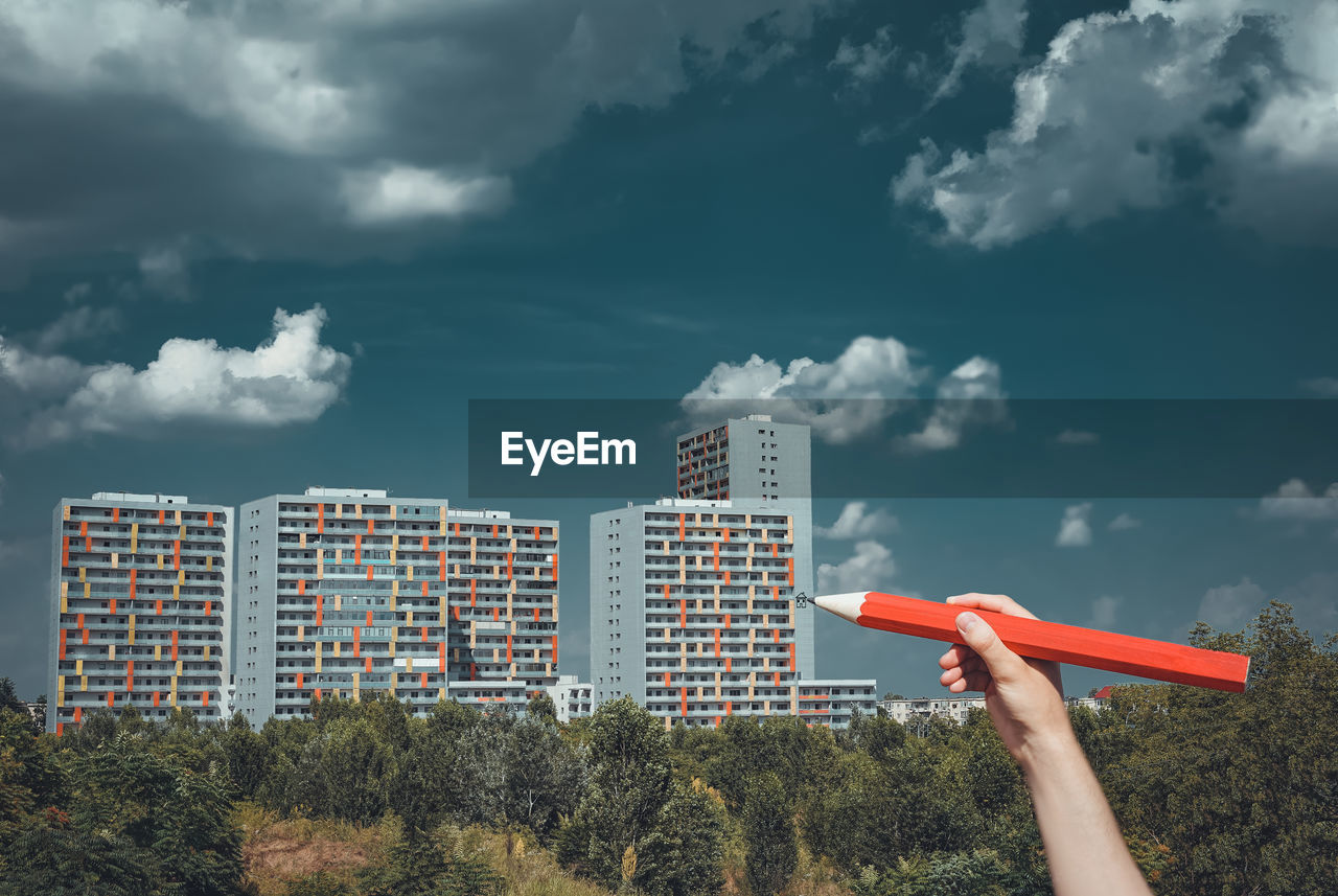 Low angle view of skyscraper against cloudy sky