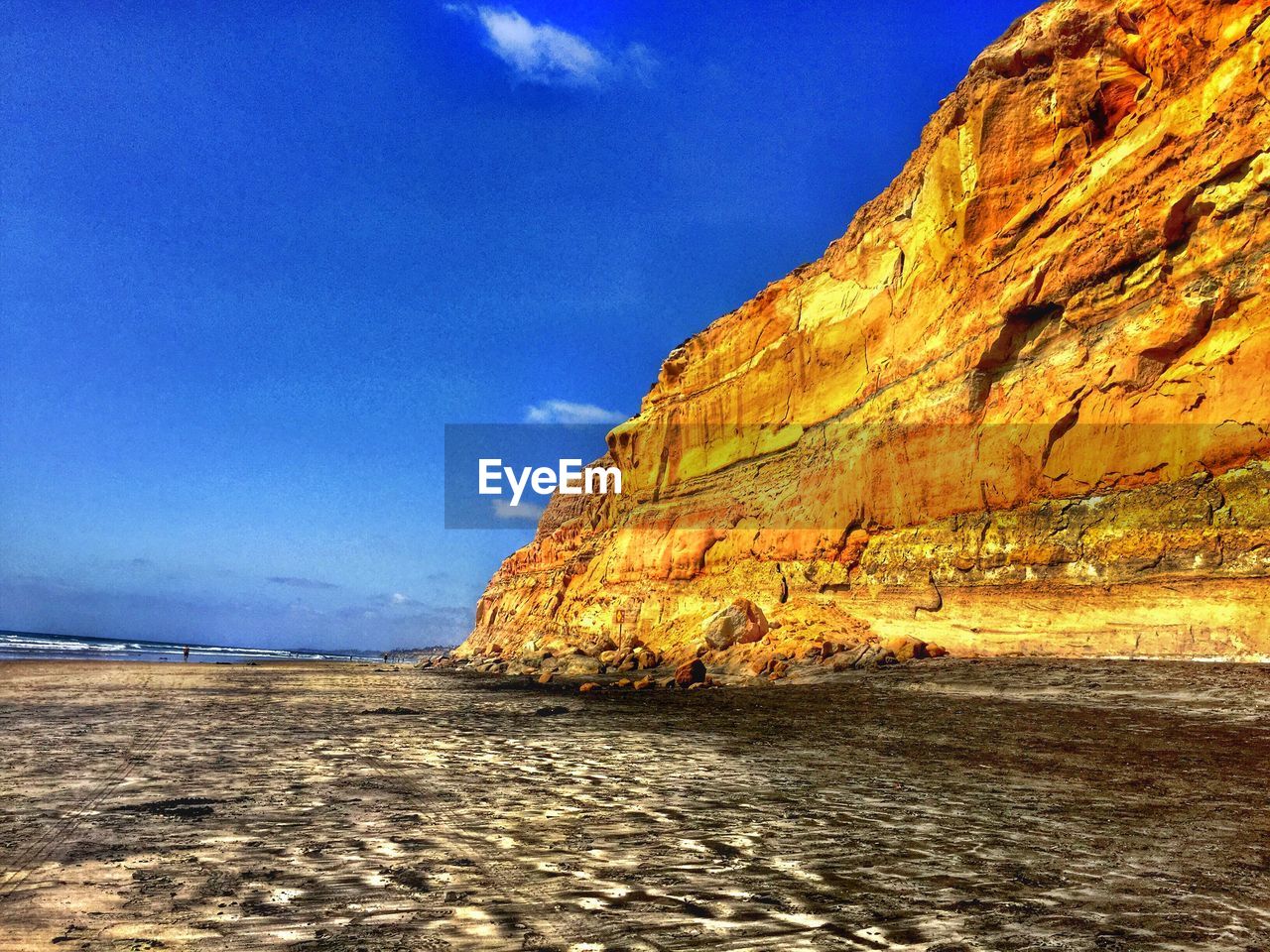 Scenic view of beach by rock formation