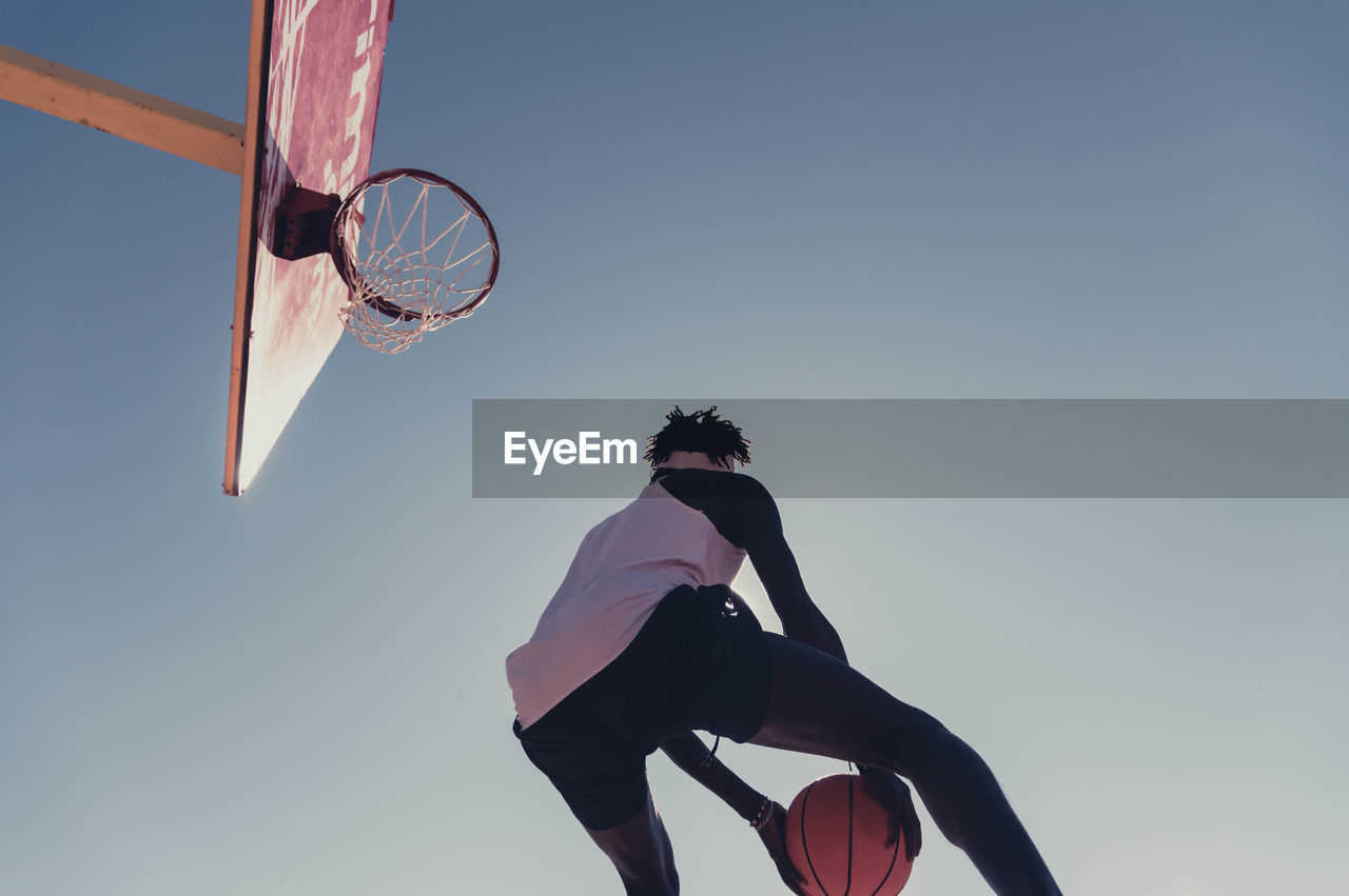 Low angle view of man playing basketball