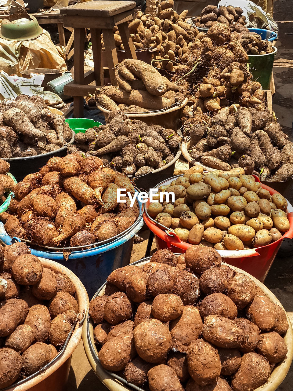 Close-up of potatoes and other root vegetables for sale at market stall, bamenda, cameroon