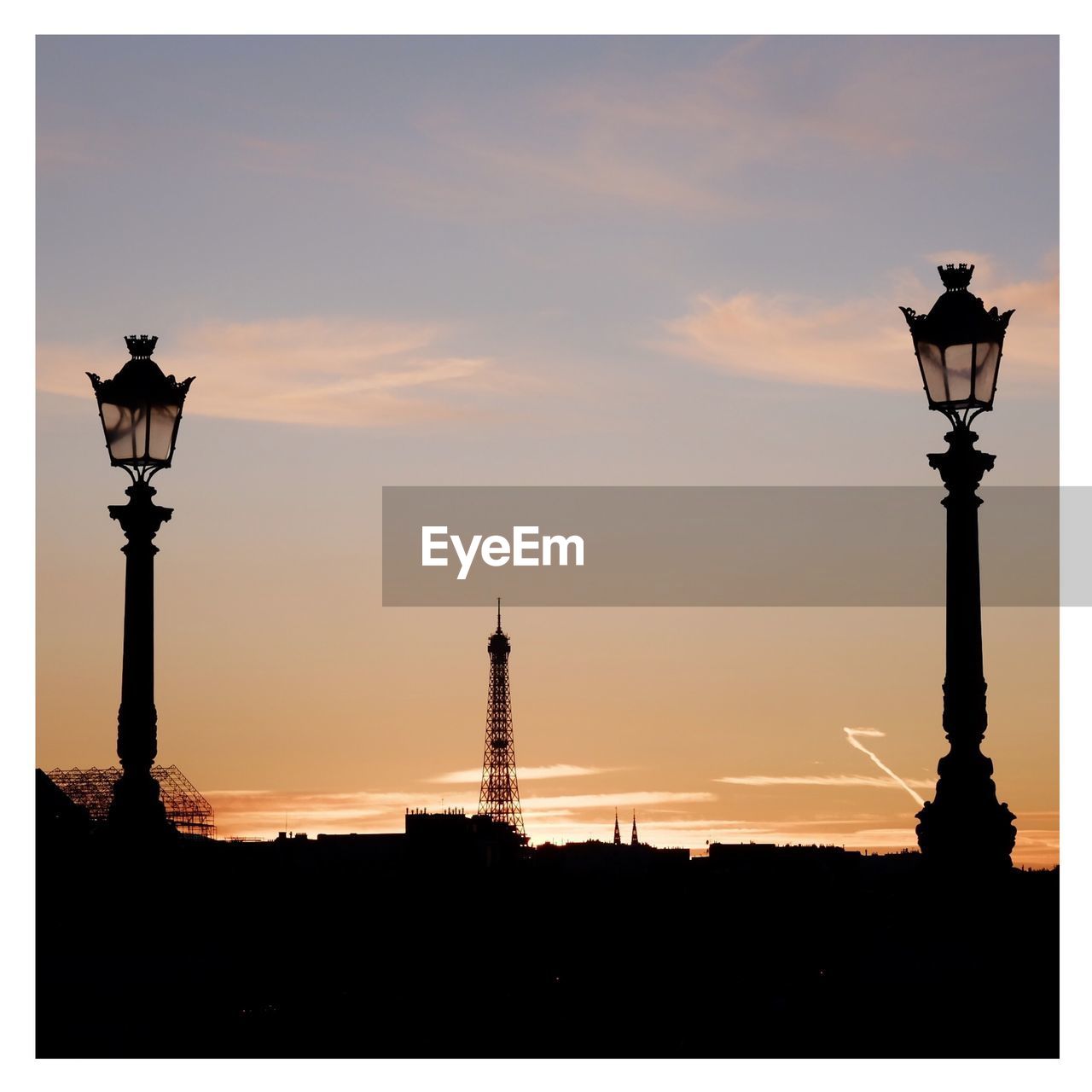 SILHOUETTE OF COMMUNICATIONS TOWER AT NIGHT