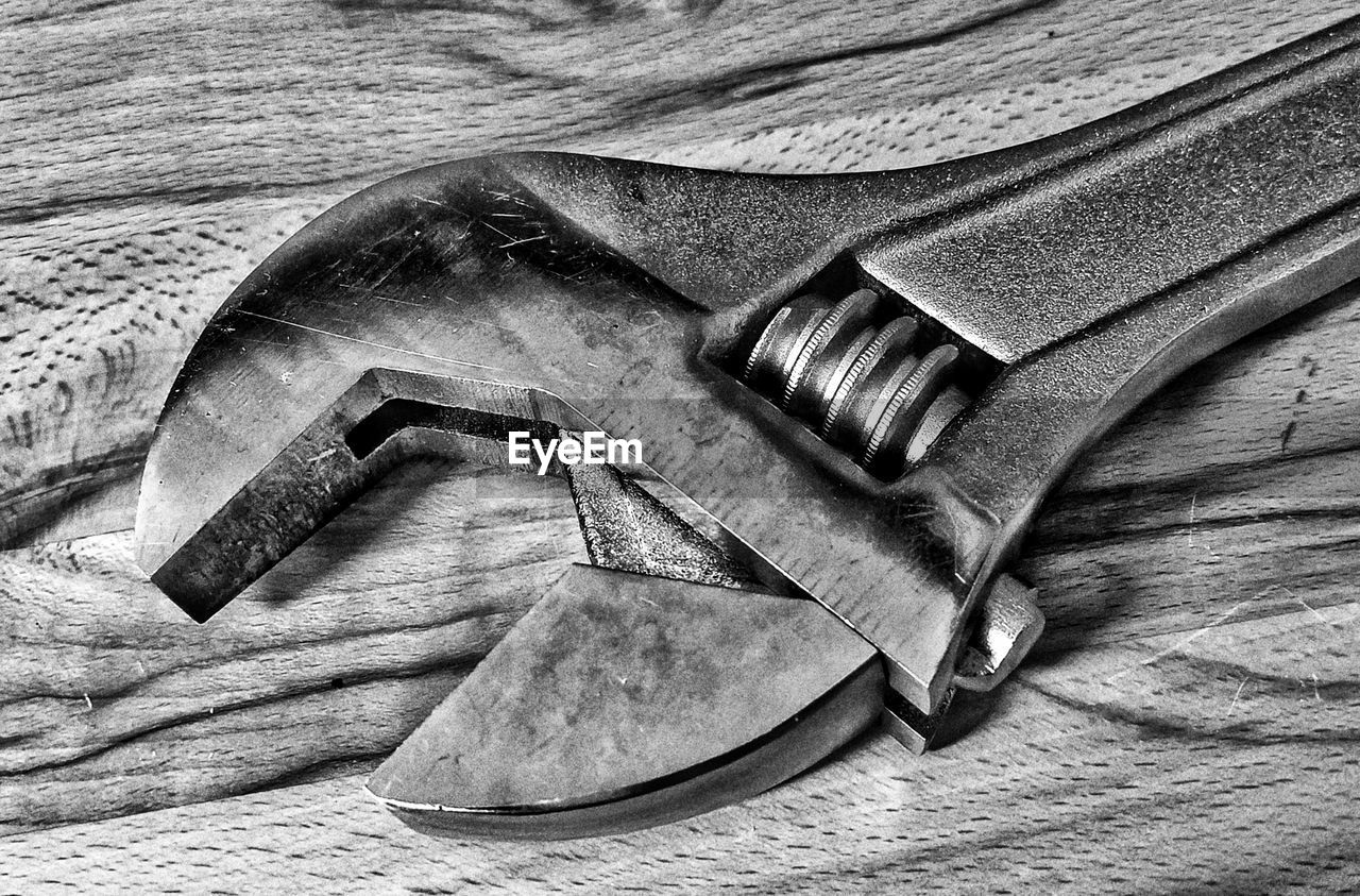 Close-up of wrench on wooden table