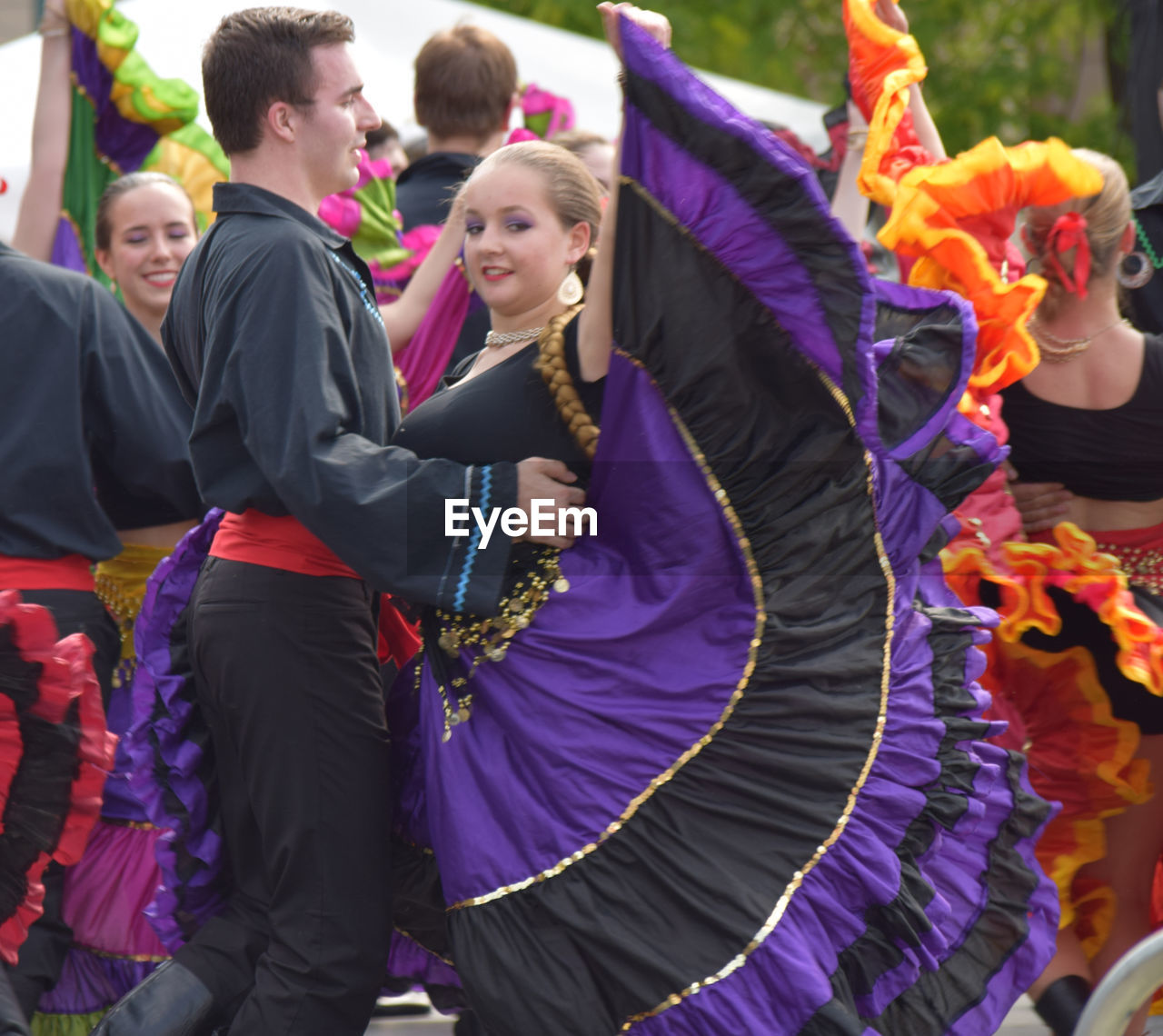 PEOPLE DANCING IN TRADITIONAL CLOTHING DURING FESTIVAL