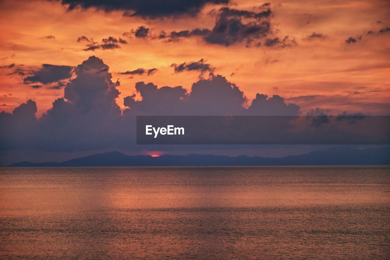 Scenic view of sea against romantic sky at sunset