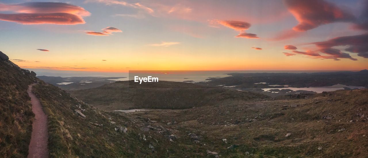 SCENIC VIEW OF LANDSCAPE AGAINST SKY AT SUNSET