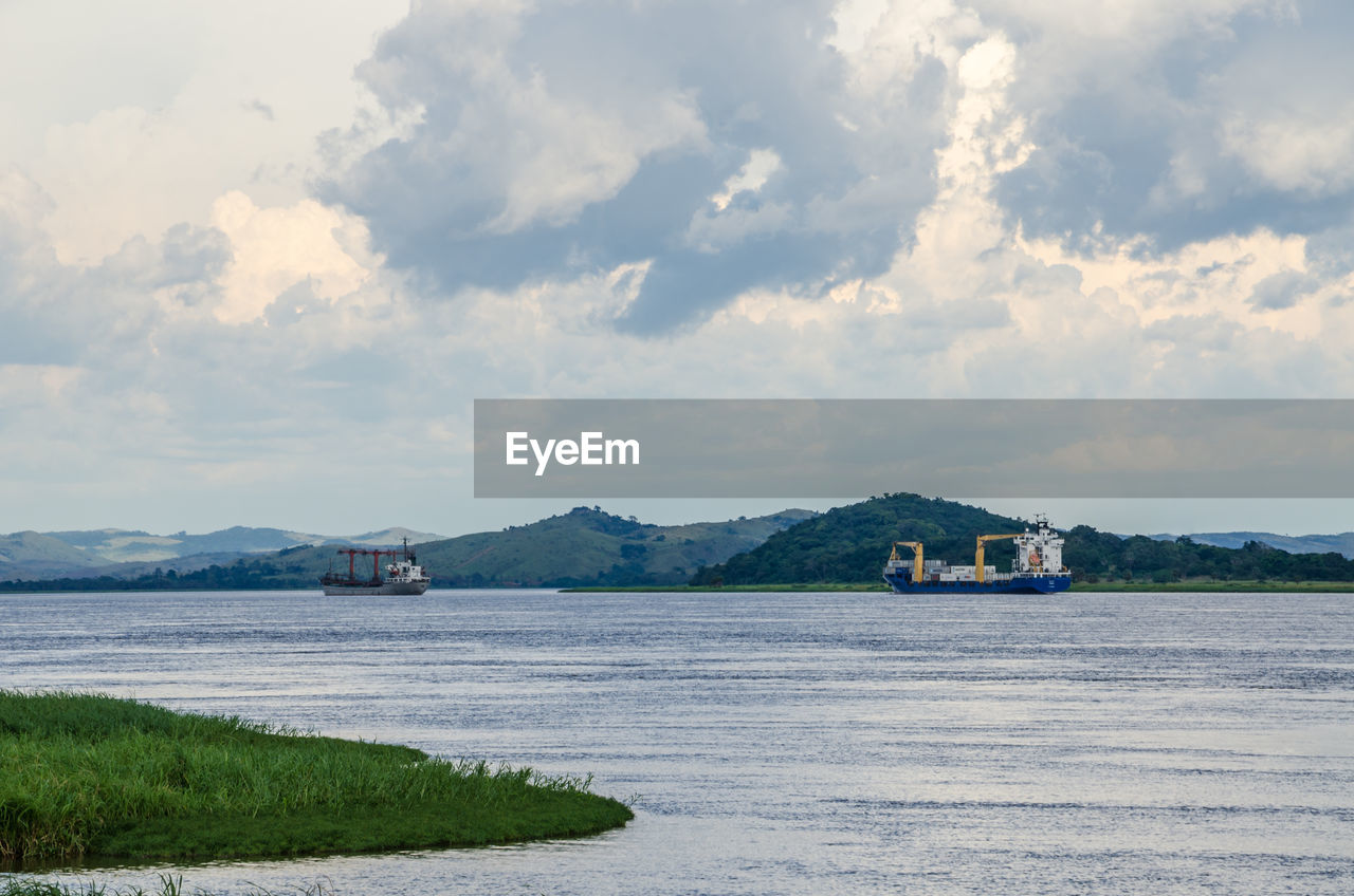 Scenic view of river congo with container ships against sky, democratic republic of congo