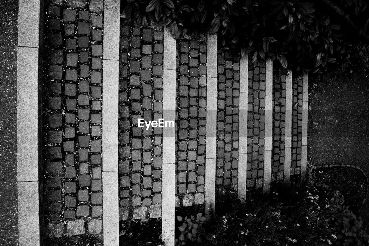 CLOSE-UP OF BRICK WALL WITH BUILDING