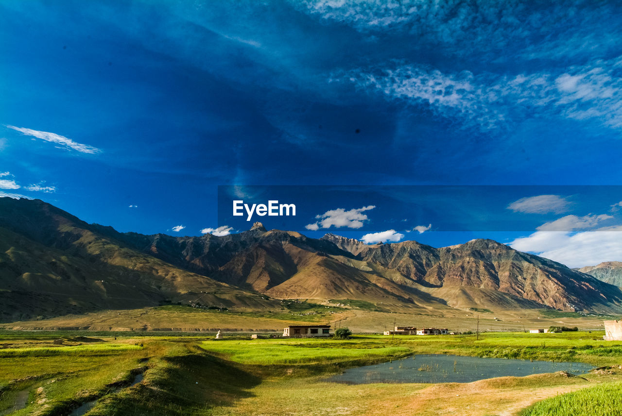 Scenic view of landscape against blue sky at night