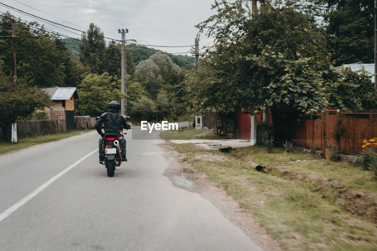 Man riding motorcycle on road