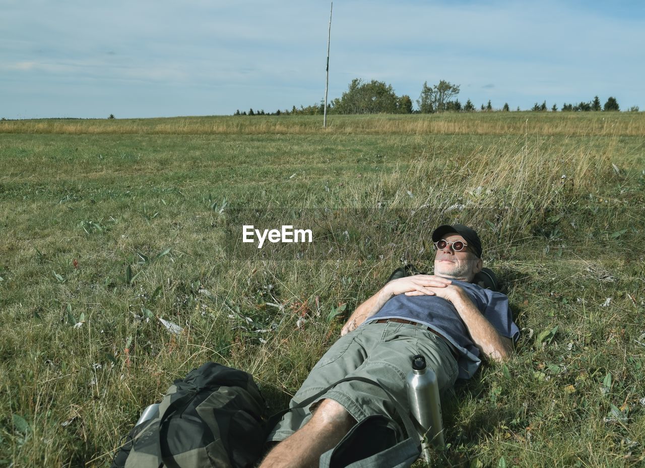 Mature man relaxing on grassy land