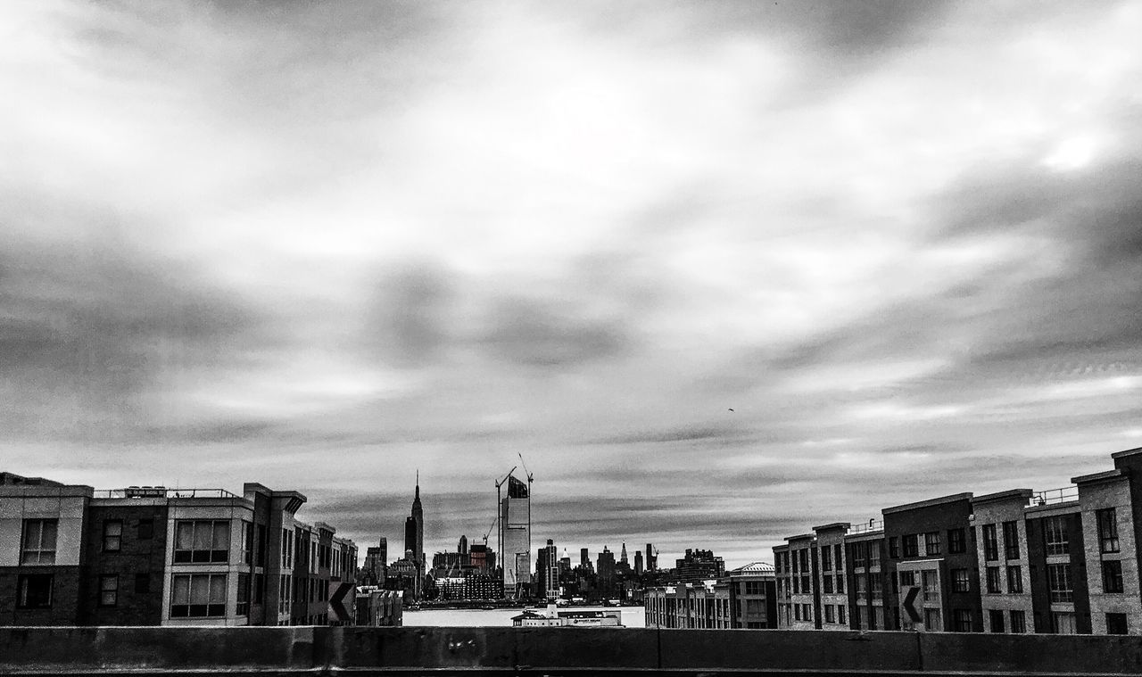 VIEW OF BUILDINGS AGAINST CLOUDY SKY