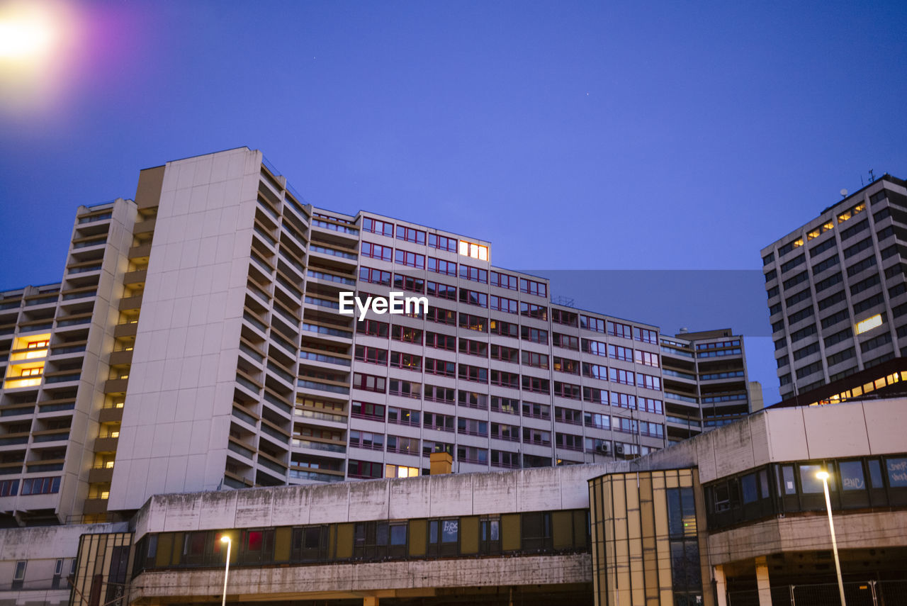 Low angle view of modern buildings against clear blue sky