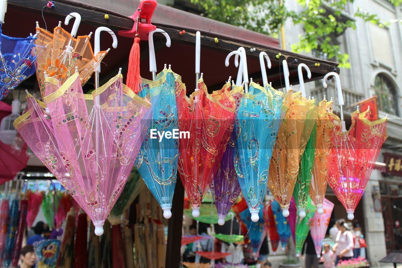 Colorful umbrellas hanging at store for sale