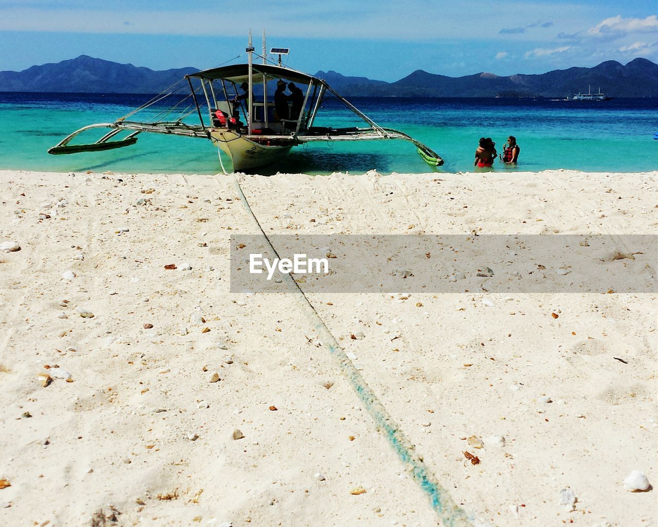 Outrigger canoe moored on beach