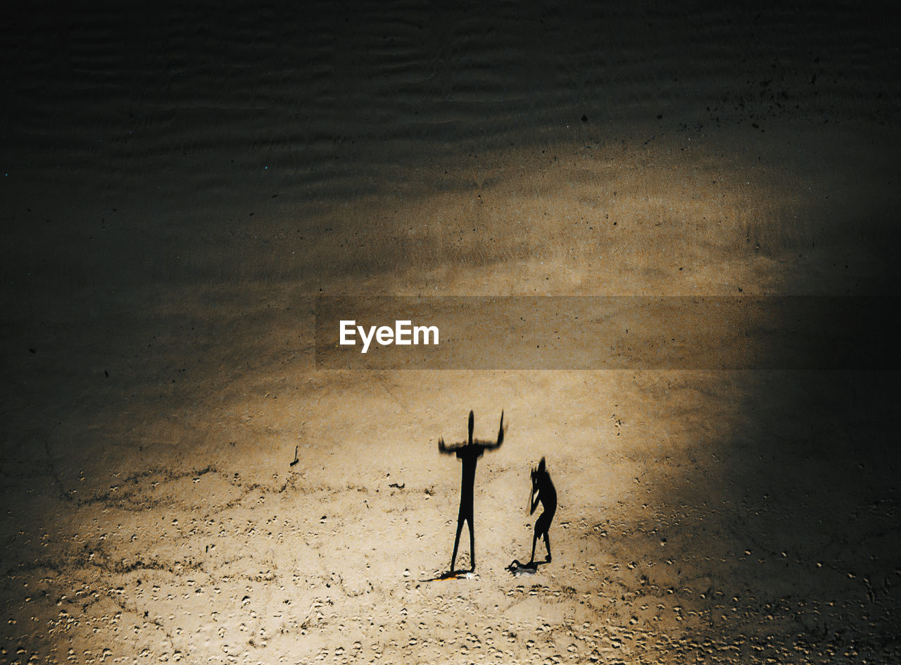 Aerial view of father and daughter at beach