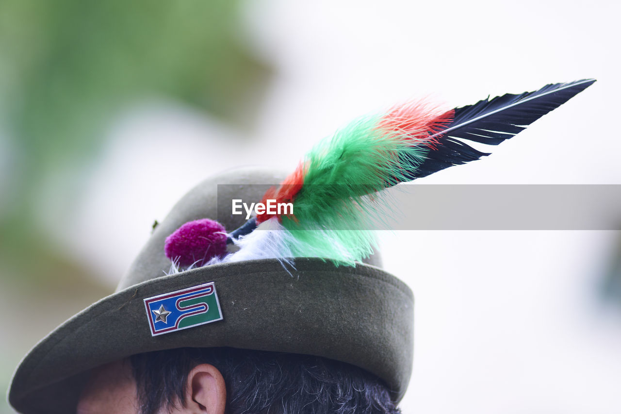 PORTRAIT OF PERSON WITH FEATHERS ON FEATHER