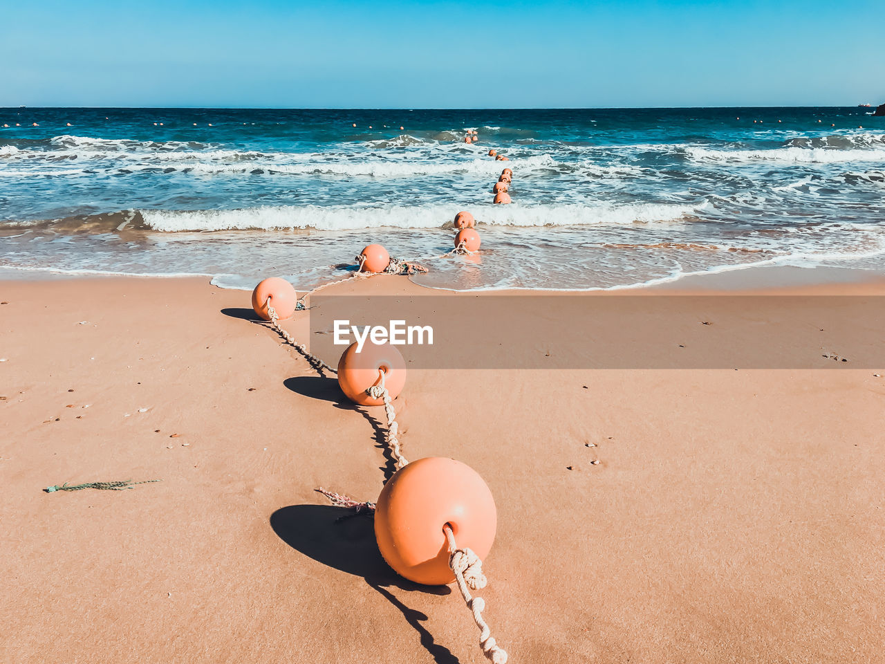 Buoys at beach on sunny day