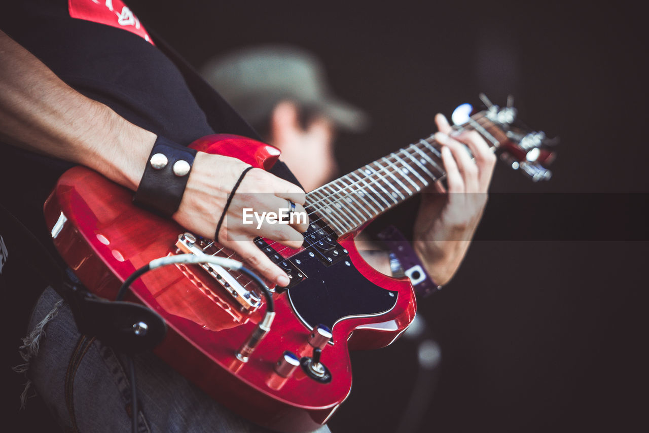 Cropped image of man playing guitar