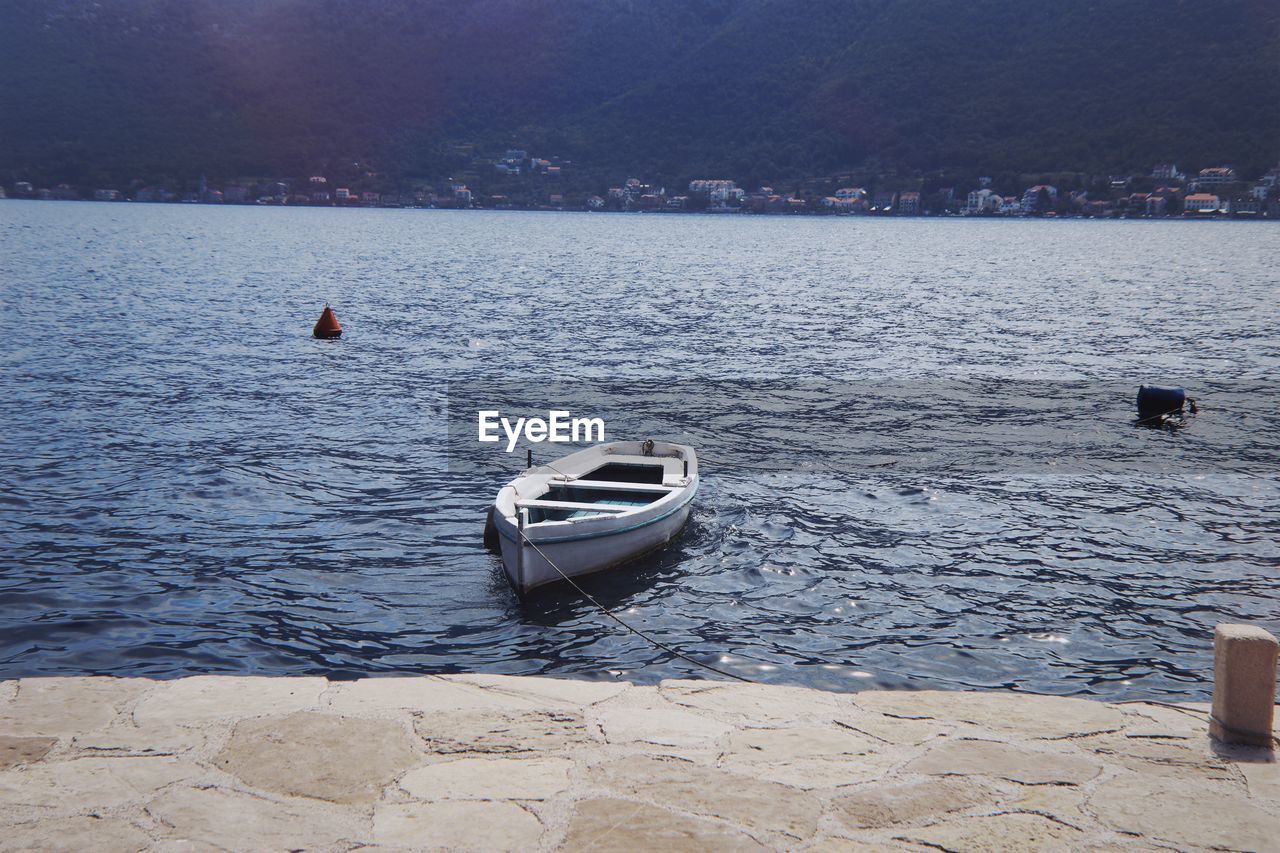 SAILBOAT MOORED ON SEA
