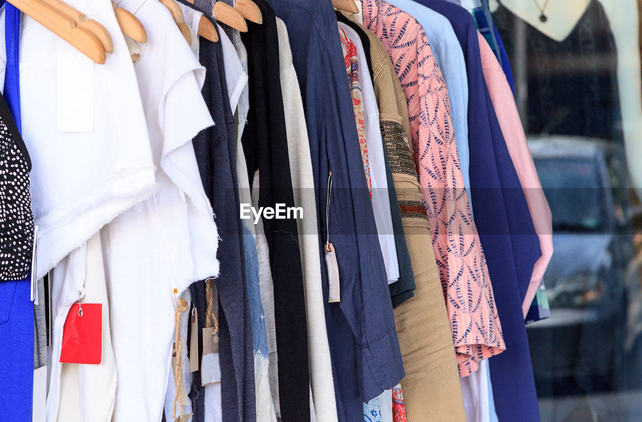 Close-up of clothes hanging in store for sale