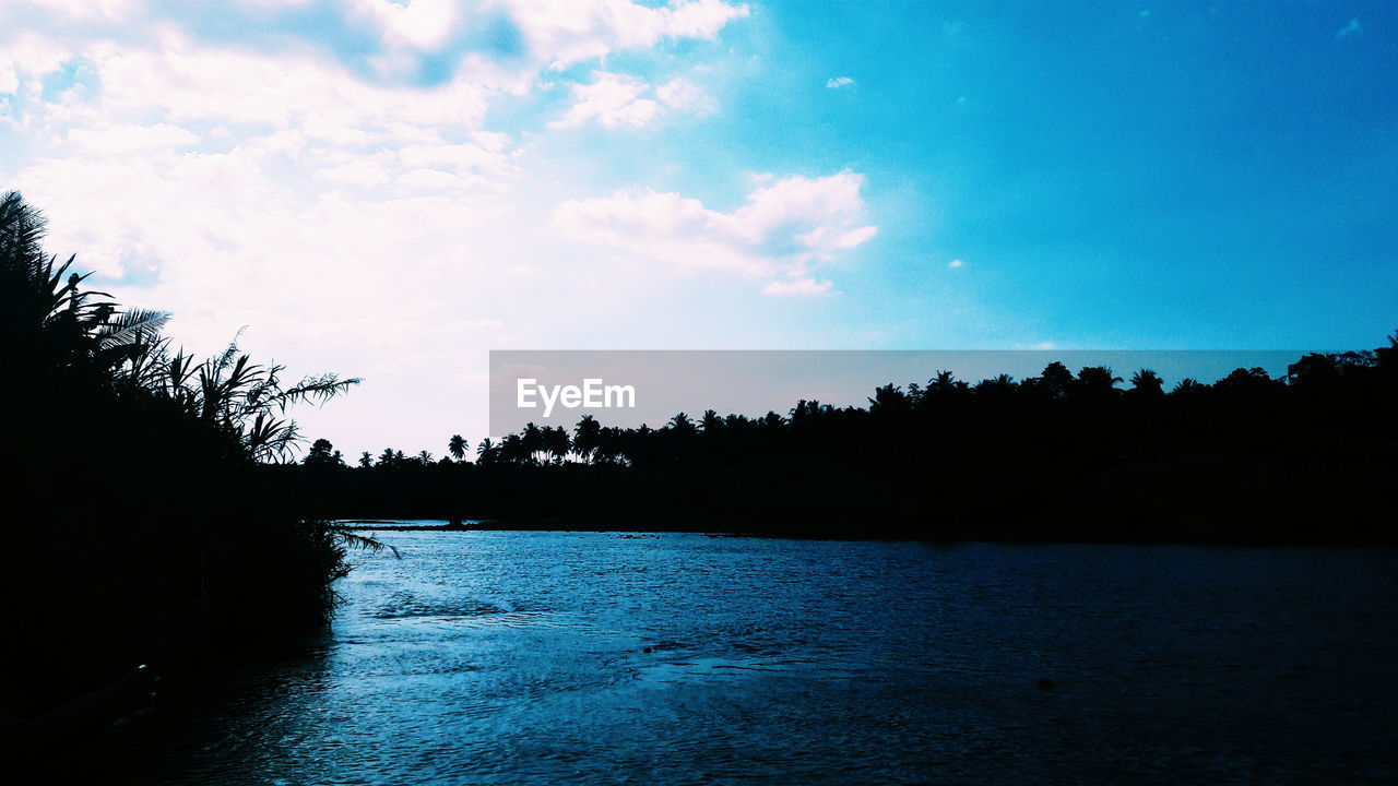 Scenic view of calm sea against cloudy sky