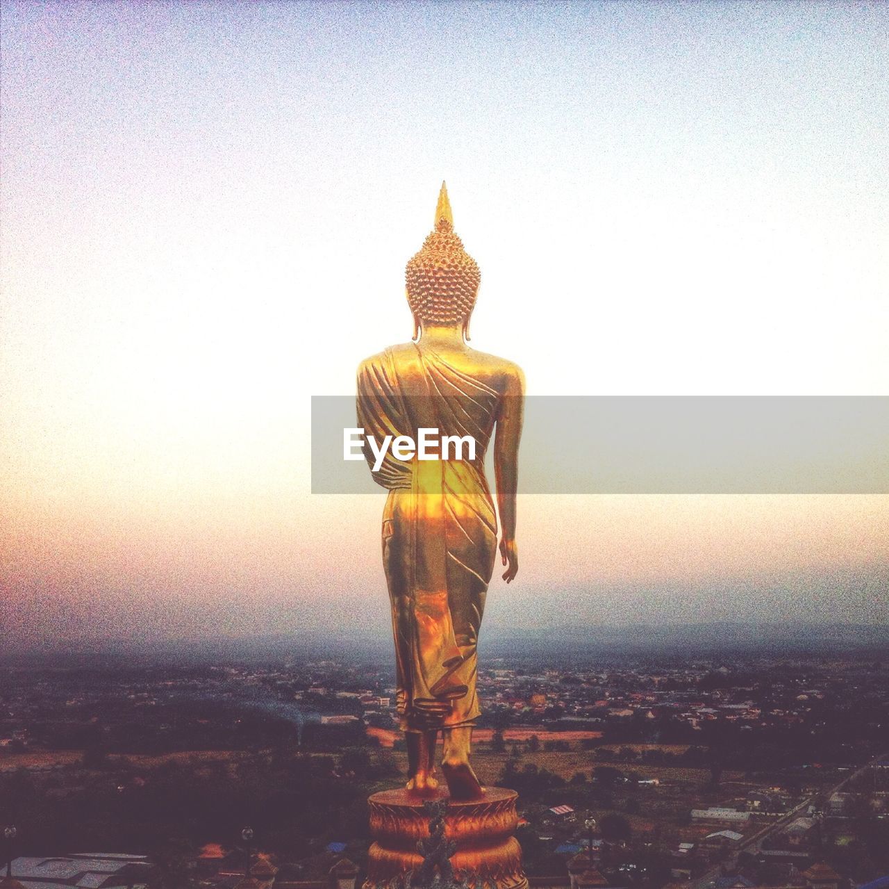 Buddha statue against clear sky at dusk