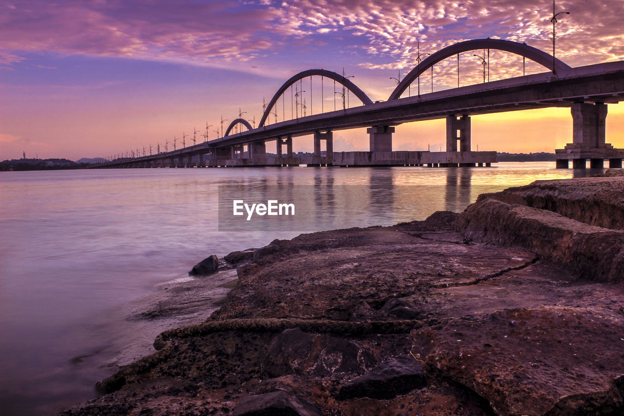 Bridge over river during sunset