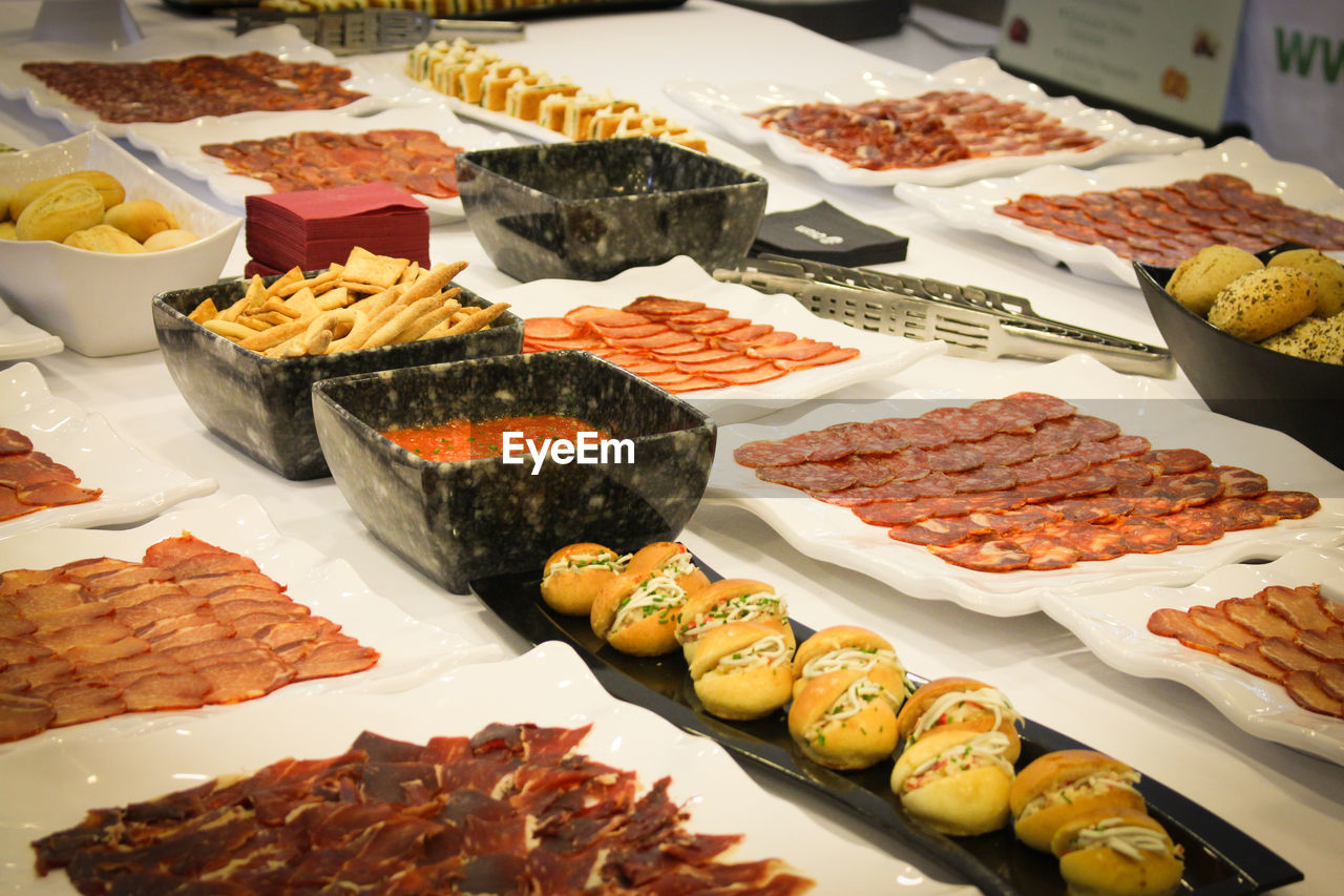 Meat arranged in plates on table